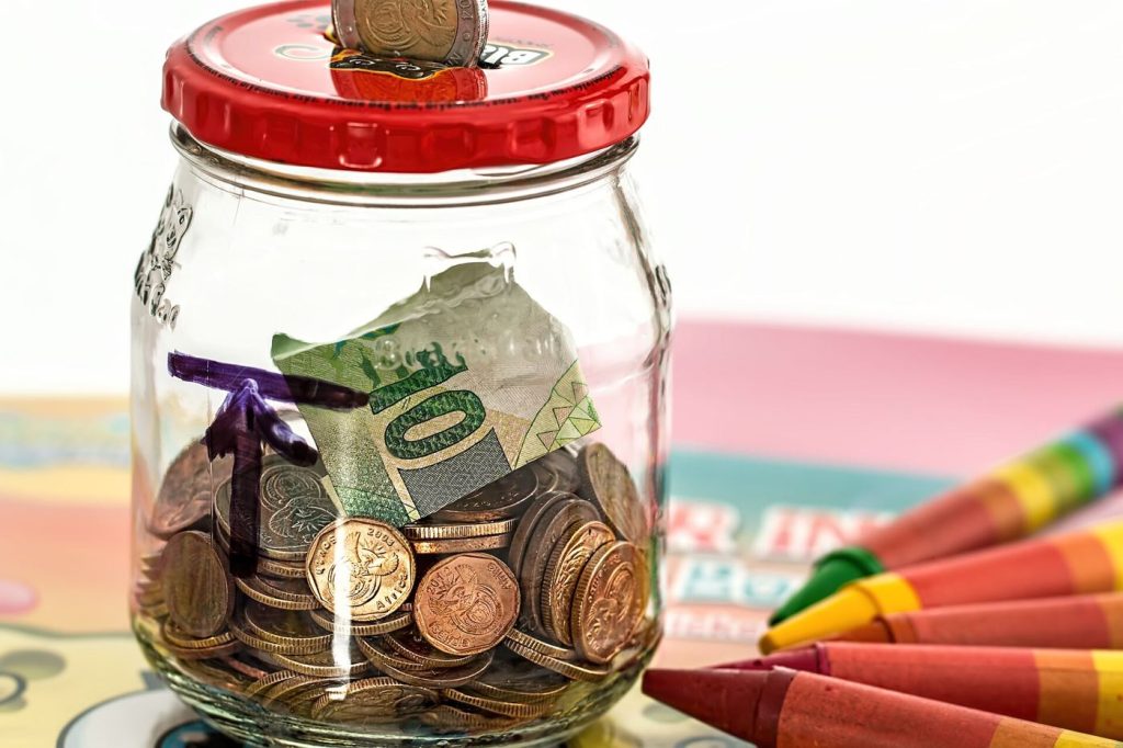Savers Lock Cash Into Term Deposits Before Rates Fall piggy bank surrounded by coins